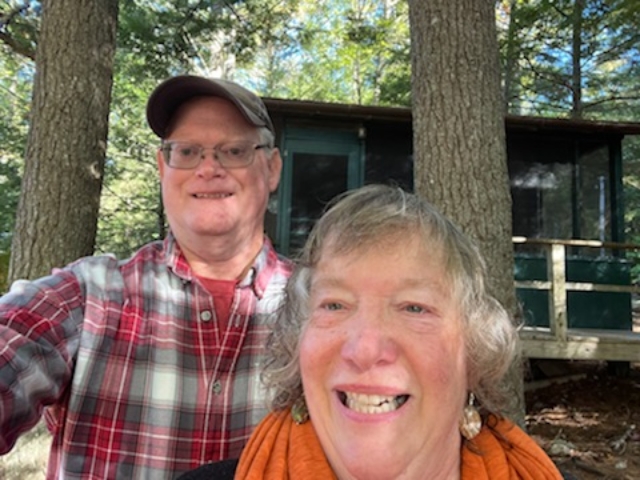 two people outside of a cabin