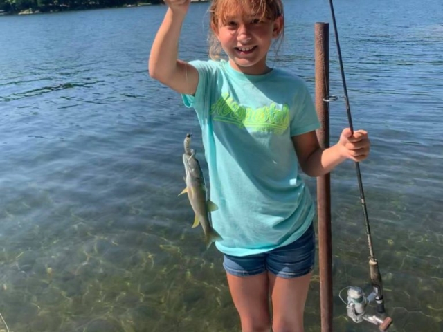 girl with fish and fishing rod