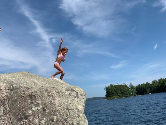 Jumping off rock into the lake