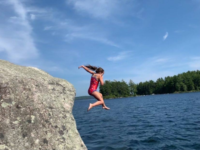 jumping off rock into a lake