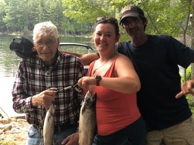three people with fish