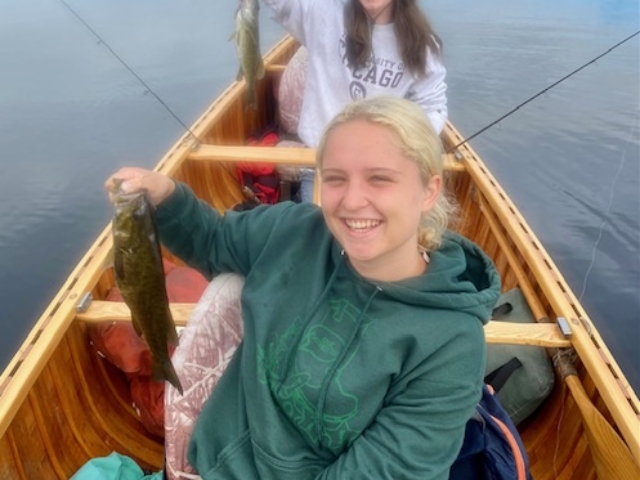 two women fishing in a canoe